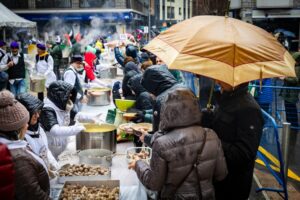Cocineros preparando escudella en Andorra la Vella bajo la lluvia