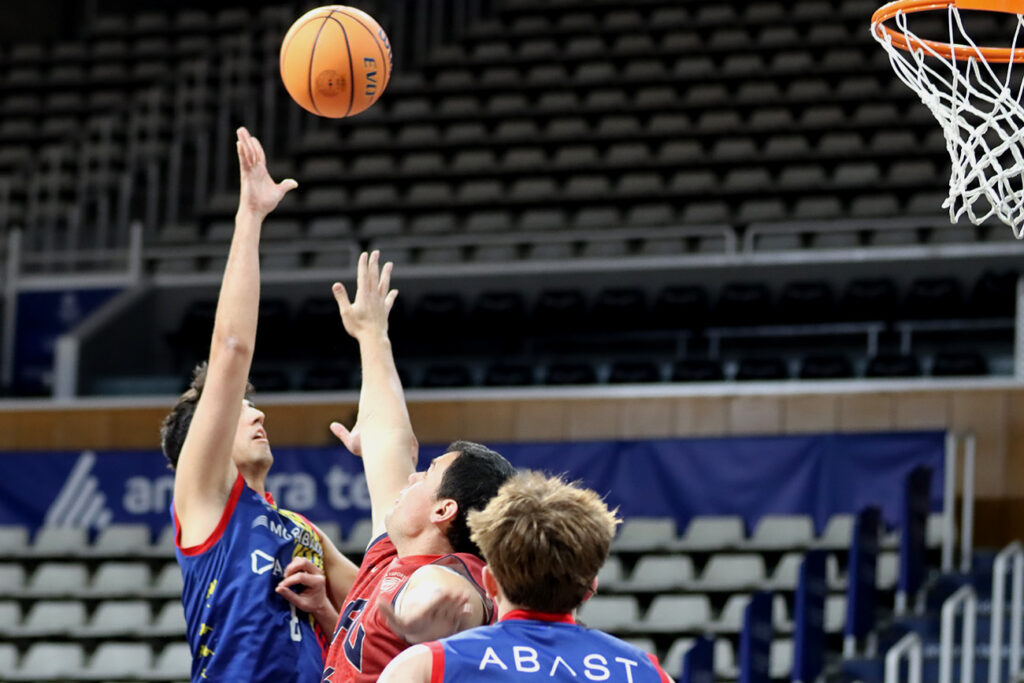 Jugador de baloncesto lanzando a canasta en un partido competitivo